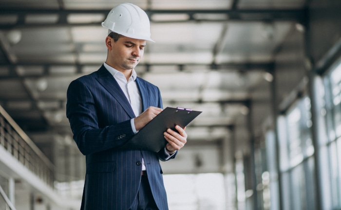 Handsome business man engineer in hard hat in a building