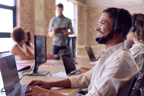 Junger Mann mit einem Headset auf dem Kopf: Bei der Consors Direkt können Jugendliche eine Ausbildung zum Kaufmann für Dialogmarketing absolvieren. (Foto: picture alliance / Shotshop | Monkey Business 2)