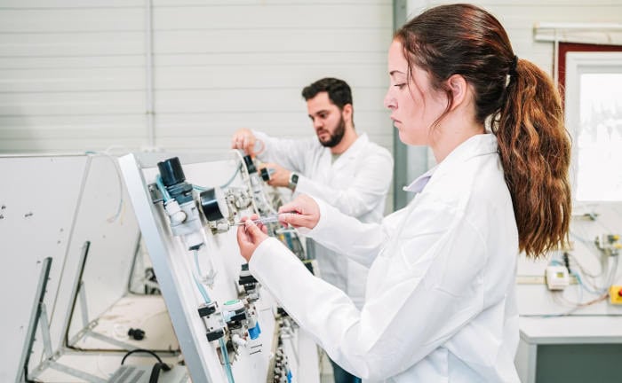 Eine junge Frau und ein junger Mann in einem technischen Labor: Ausbildungsberufe im Bereich Forschung und Entwicklung sind für 20 bis 39-Jährige am lukrativsten.