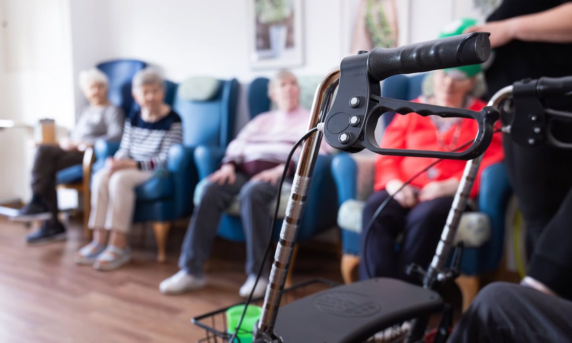 Frau mit Rollator im Pflegeheim: Eine Kommission arbeitet derzeit an einer Pflegereform.
